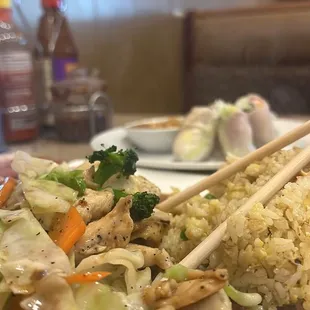 Chicken stir fry with fried rice and spring rolls