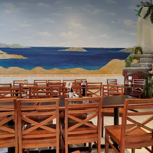 a dining room with a view of the ocean