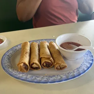  plate of food and a bowl of dipping sauce
