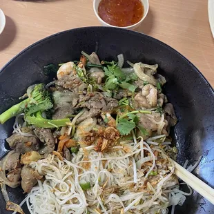 a plate of noodles and meat