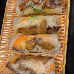 four rolls of food wrapped in plastic