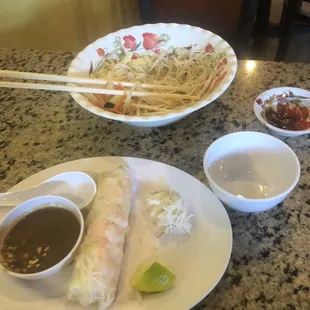 a plate of food and a bowl of dipping sauce