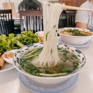 a bowl of soup with noodles and vegetables