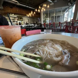 a bowl of soup and chopsticks