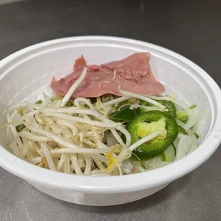 a bowl of noodles and meat