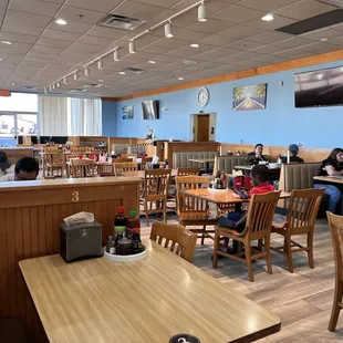 people sitting at tables in a restaurant
