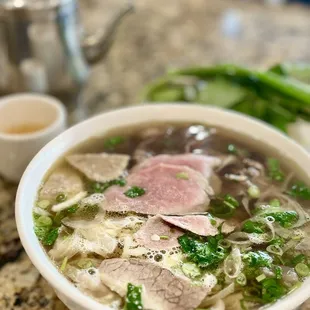 a bowl of soup with meat and vegetables