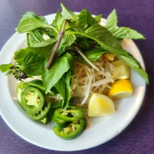 Bean sprouts, basil, jalapeños and lemon wedges
