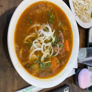 a bowl of soup and a phone