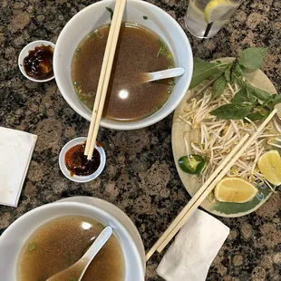 two bowls of soup and chopsticks