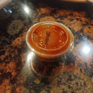 Sriracha rationing... Can't tell by the picture, but this container is like the size of a large thimble.