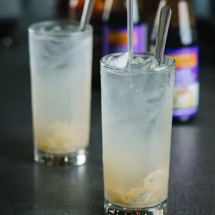 a close up of a drink with ice and a straw