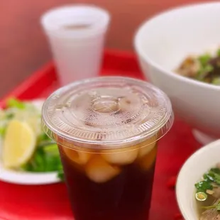 two bowls of soup and a drink