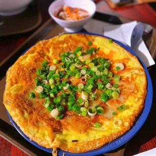 an omelet with green onions