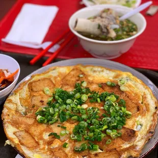 an omelet and a bowl of noodles