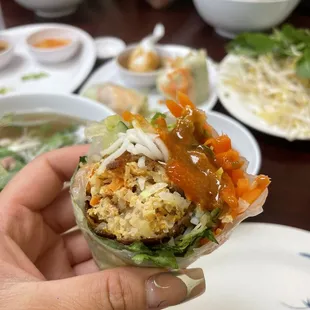 a person holding a wrap of food