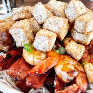 a plate of food with tofu and shrimp