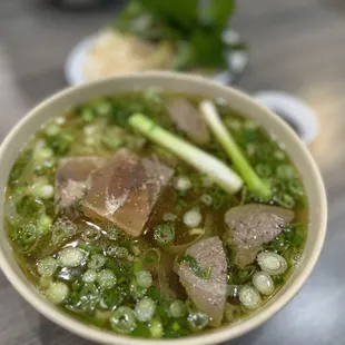 a bowl of soup with meat and vegetables