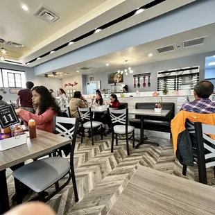 people sitting at tables in a restaurant