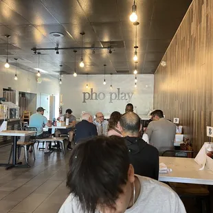 people sitting at tables in a restaurant