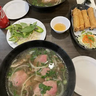 Medium rare slice steak with brisket pho and egg rolls