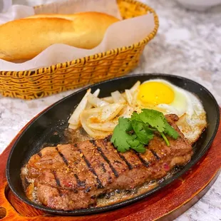 a steak and eggs in a skillet