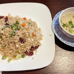 a plate of fried rice and a bowl of soup