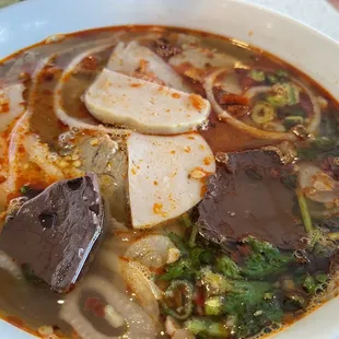 a bowl of soup with meat and vegetables