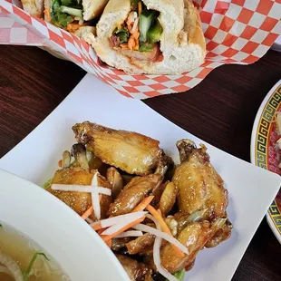 Sweet and spicy chicken wings charred Bahn mi sandwich and combination pho