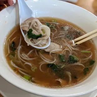 a bowl of soup with noodles and meat