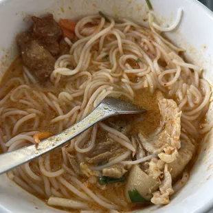 Kapoon $16.99 Pork broth with coconut red curry and crispy pork belly Served with vermicelli noodle, crispy pork belly &amp; shredded veggies