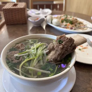a bowl of soup with meat and vegetables