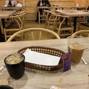 Iced coffee with ice removed on table &amp; in my water mug after they filled it up more