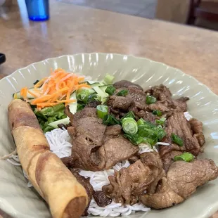64. Vermicelli with grilled pork and one egg roll.