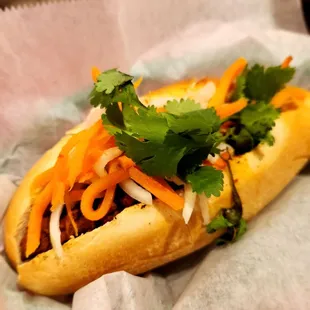 a hot dog with various toppings