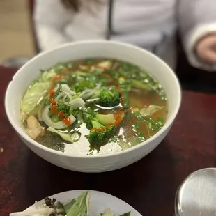 a bowl of soup and a plate of salad