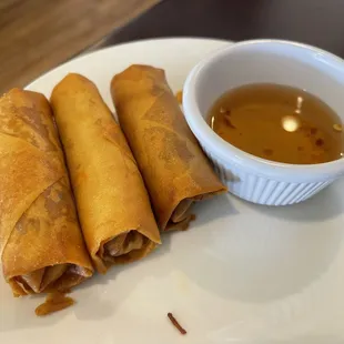 three spring rolls with dipping sauce
