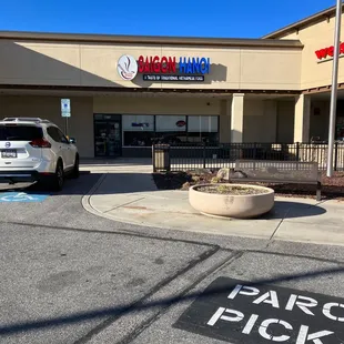 a parking lot with a parking pick up sign