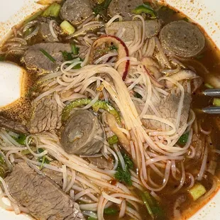 a bowl of soup with meat and noodles