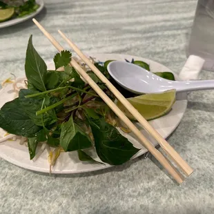 a plate of noodles and chopsticks