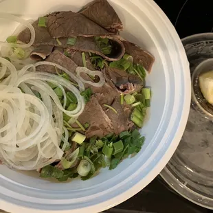 a bowl of beef and noodles