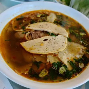 a bowl of soup with meat and vegetables