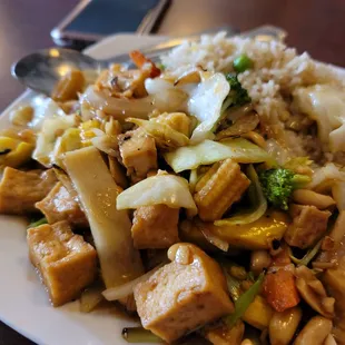 a plate of stir fried tofu and vegetables