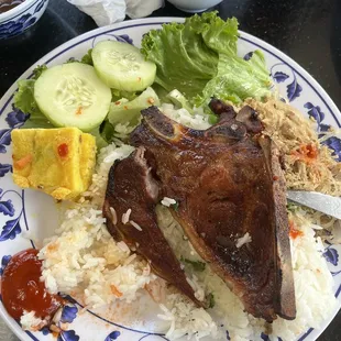 Marinated pork chop, steamed egg with vermicelli and pork patty, and shredded pork skin on white rice.  My favorite!