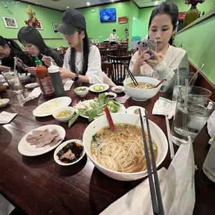 a group of people eating at a restaurant
