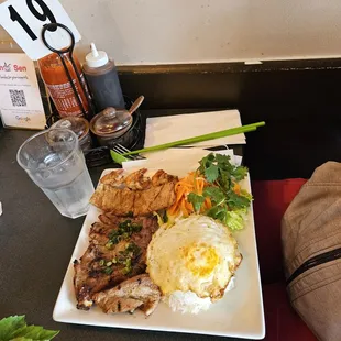 Grilled pork chop with grilled shrimp.  Along with omelet egg on top of jasmine rice.