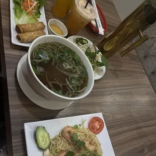 Egg rolls, brisket pho, shrimp garlic noodles, Thai tea, and passion fruit tea