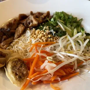 Vietnamese noodles with egg rolls and grilled pork