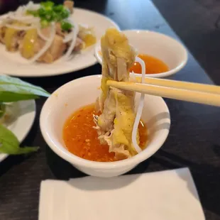 a bowl of noodles with chopsticks