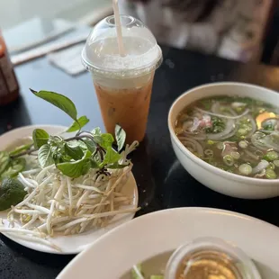 two bowls of soup and a drink